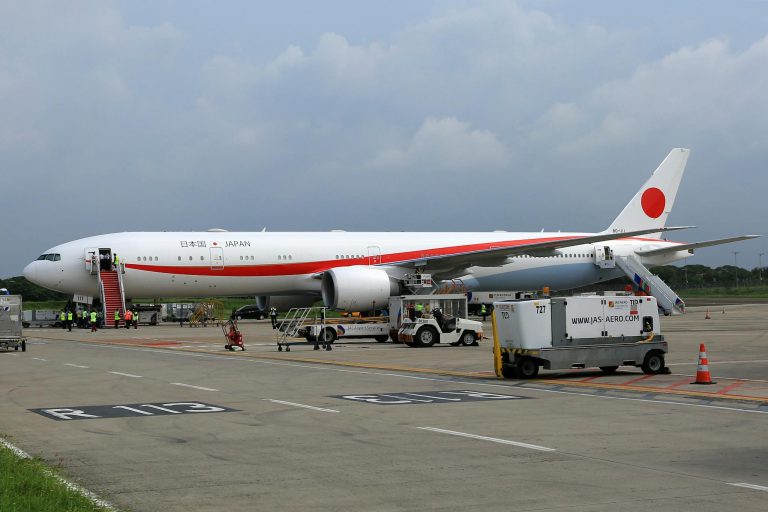 Japanese Government airplane parked on tarmac, preparing for departure.